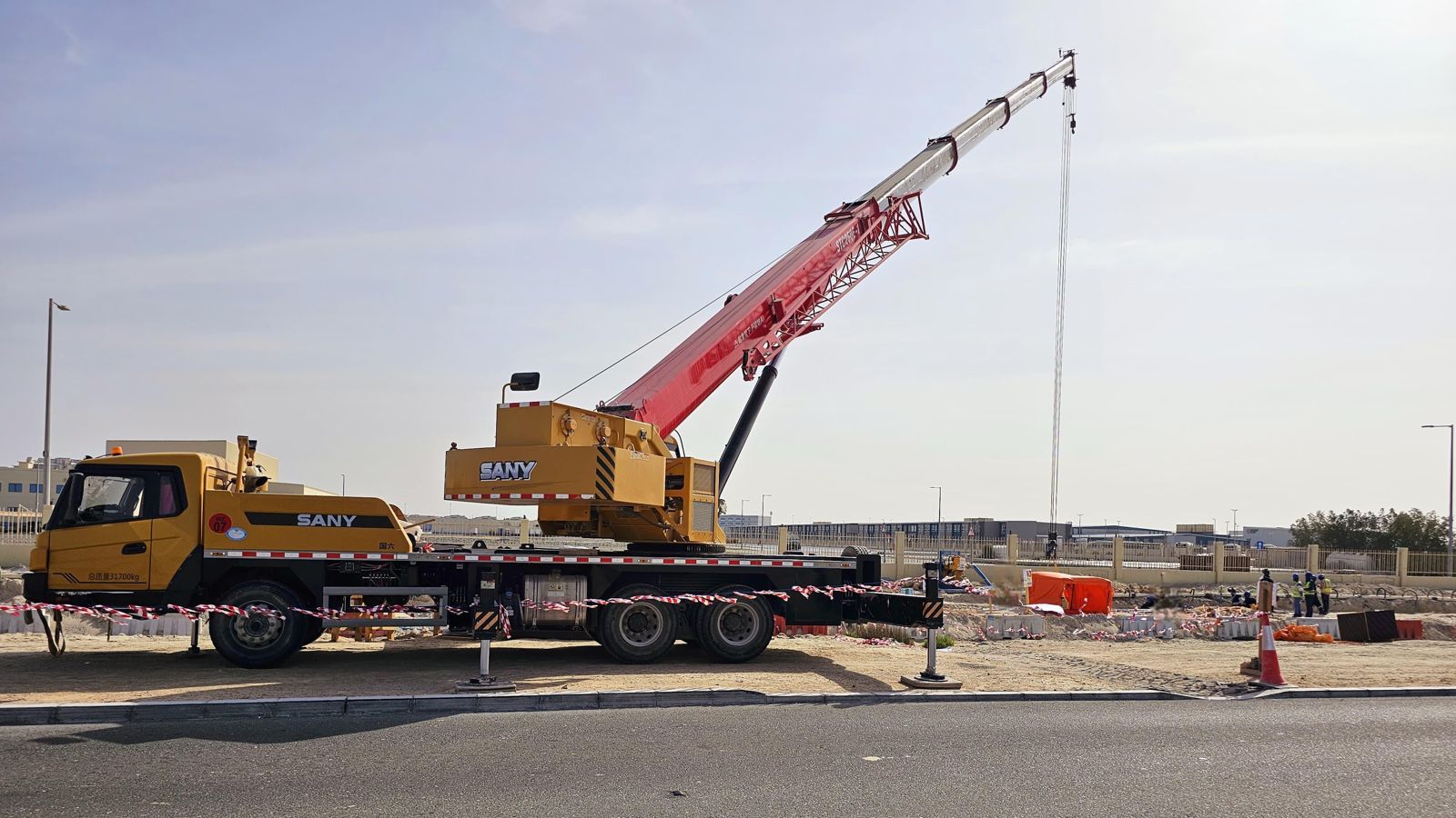 Mobile crane set up on outriggers at a construction site in the UAE